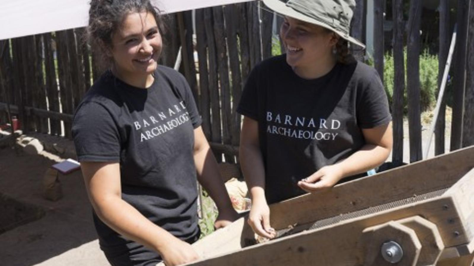 2 Barnard students working at a field site